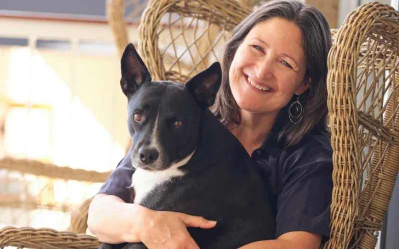 Professional with a dog featured in SVMG veterinary branding and client relationship marketing.